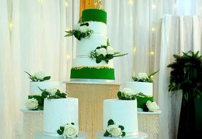 Green and white 4-tier wedding cake with matching minis and white roses