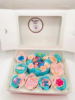 Gift box of Lilo and Stitch themed cupcakes with a mini heart cake in the centre
