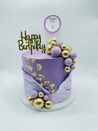 Purple marble ombre cake with gold leaf and lilac and gold spheres